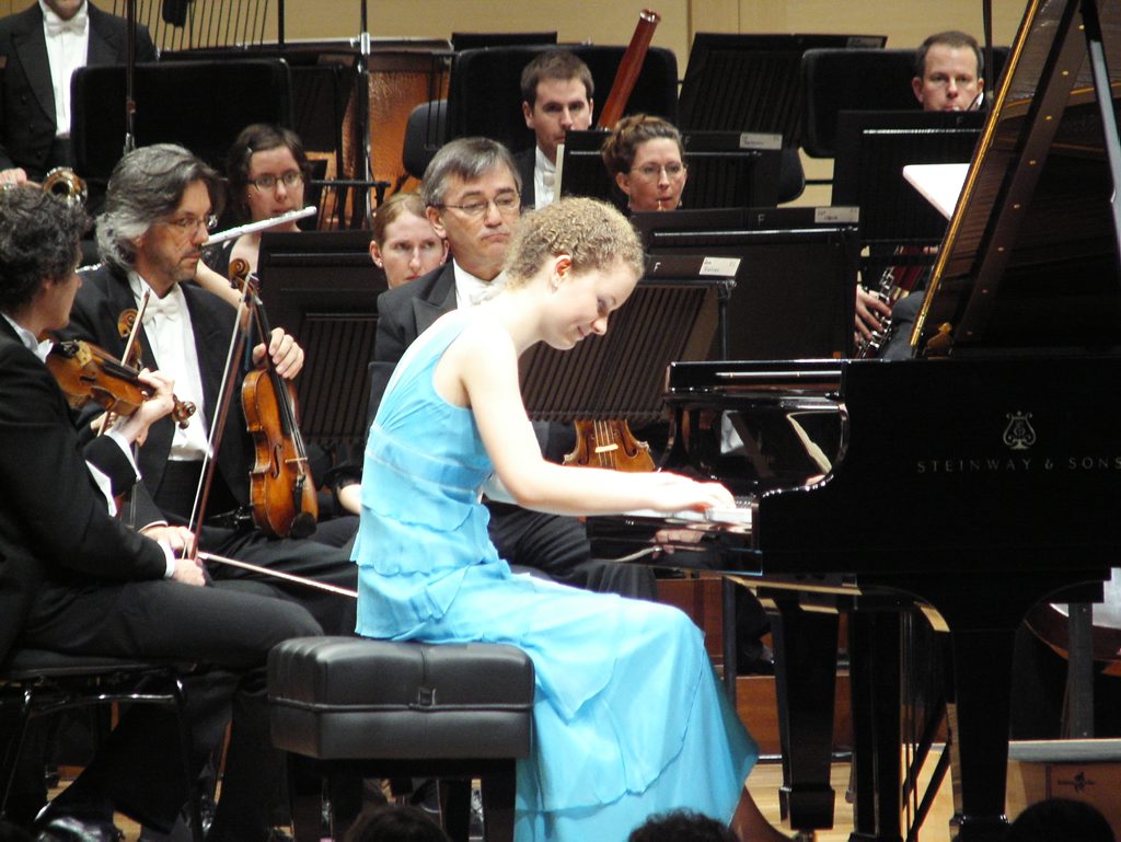 Ayesha Gough giving it her all on the piano backed by an orchestra. Ayesha Gough giving it her all on the piano backed by an orchestra.